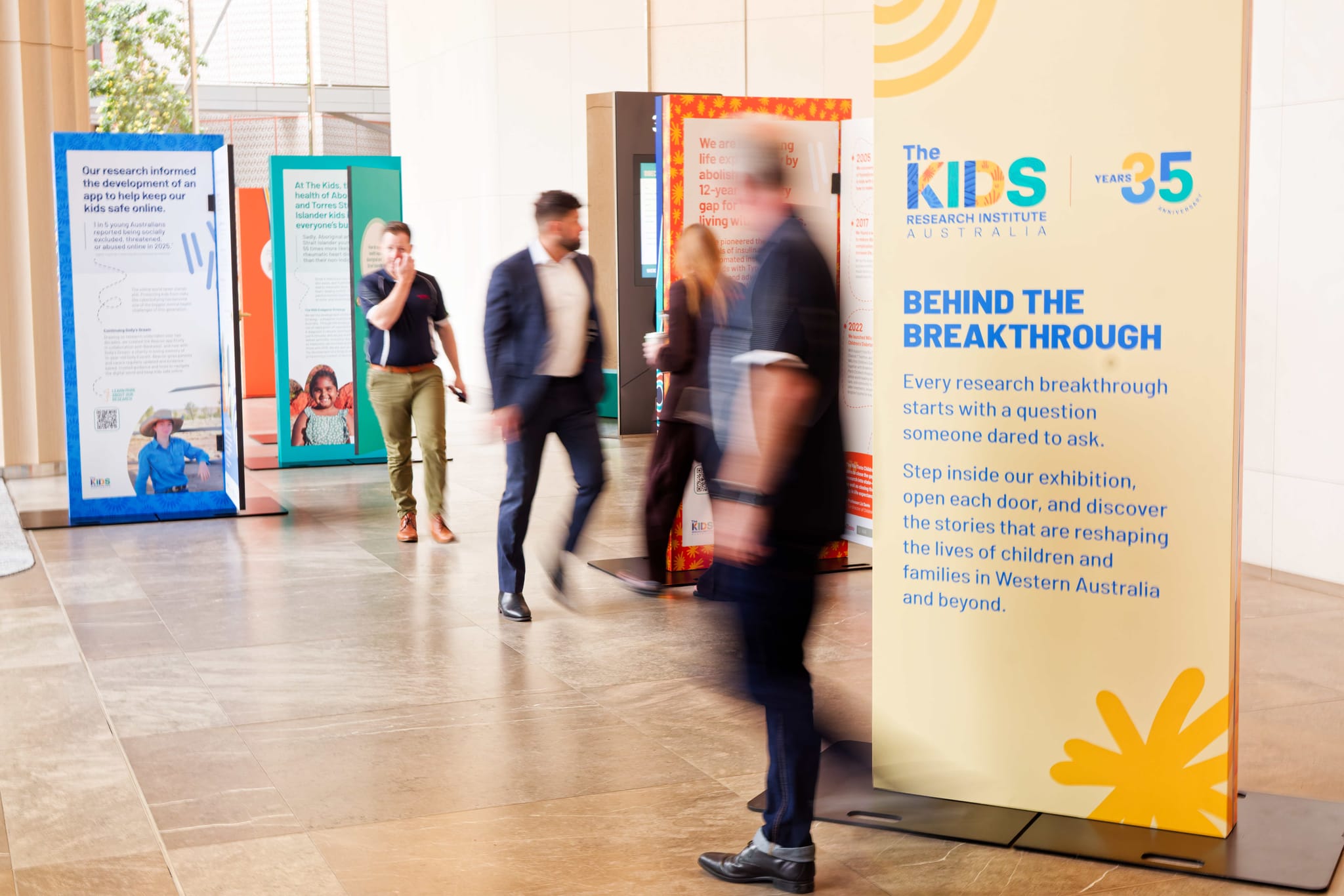 people walking through exhibition